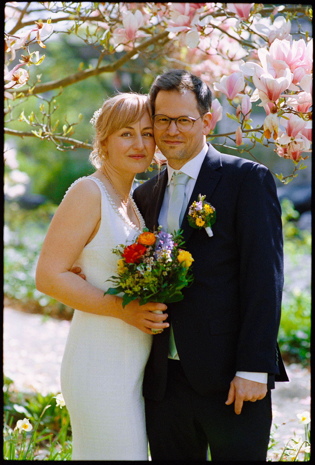The couple among magnolia blossom, Irena & Peter wedding in Berlin