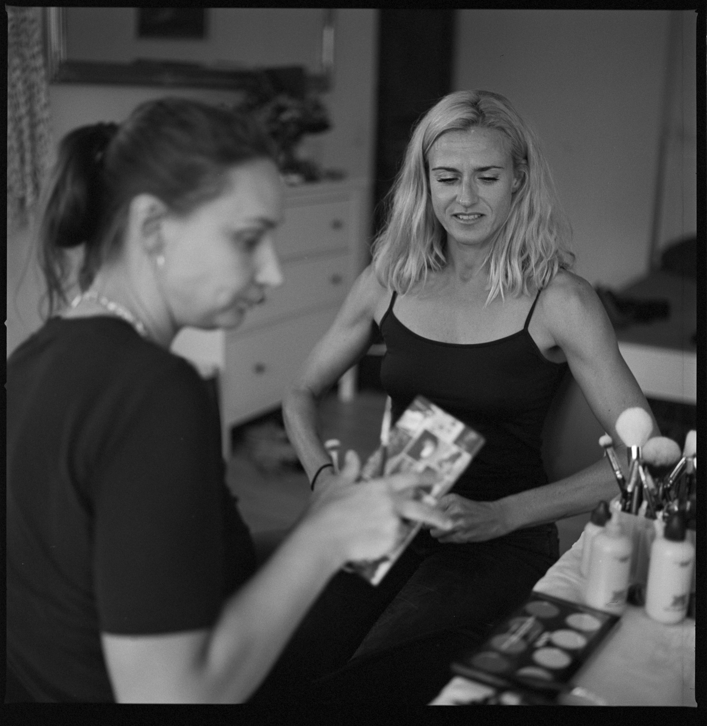The bride having her make-up done while getting ready, black and white, Linda & Thomas wedding in Berlin