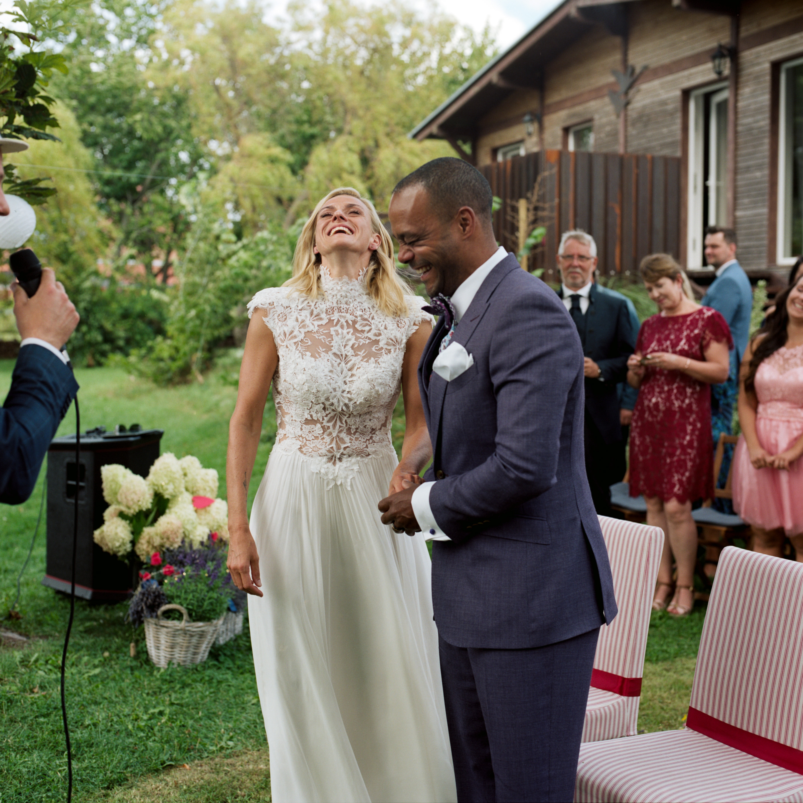 The bride and groom standing together during the garden ceremony, Linda & Thomas wedding in Berlin