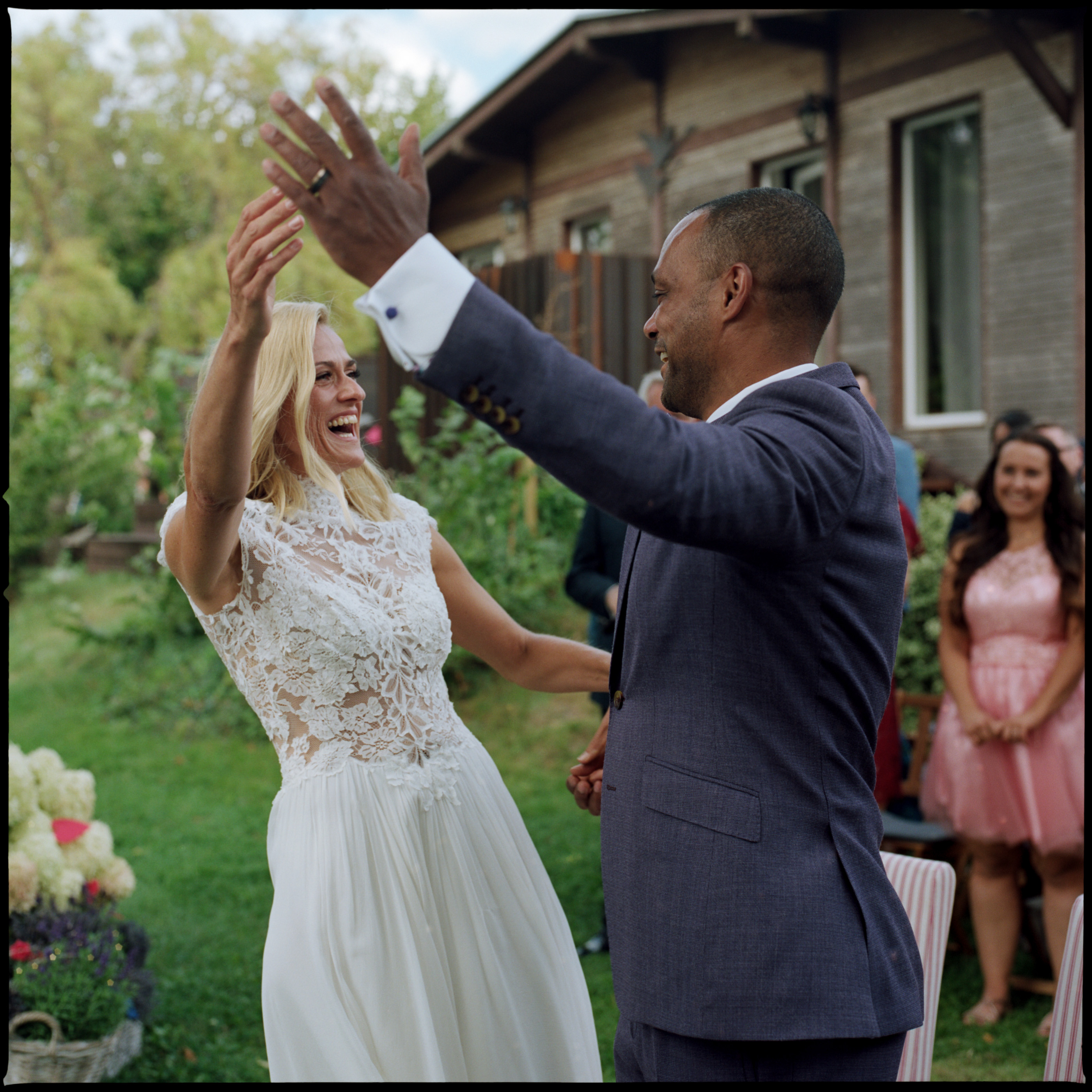 The couple laughing and raising their hands together, Linda & Thomas wedding in Berlin