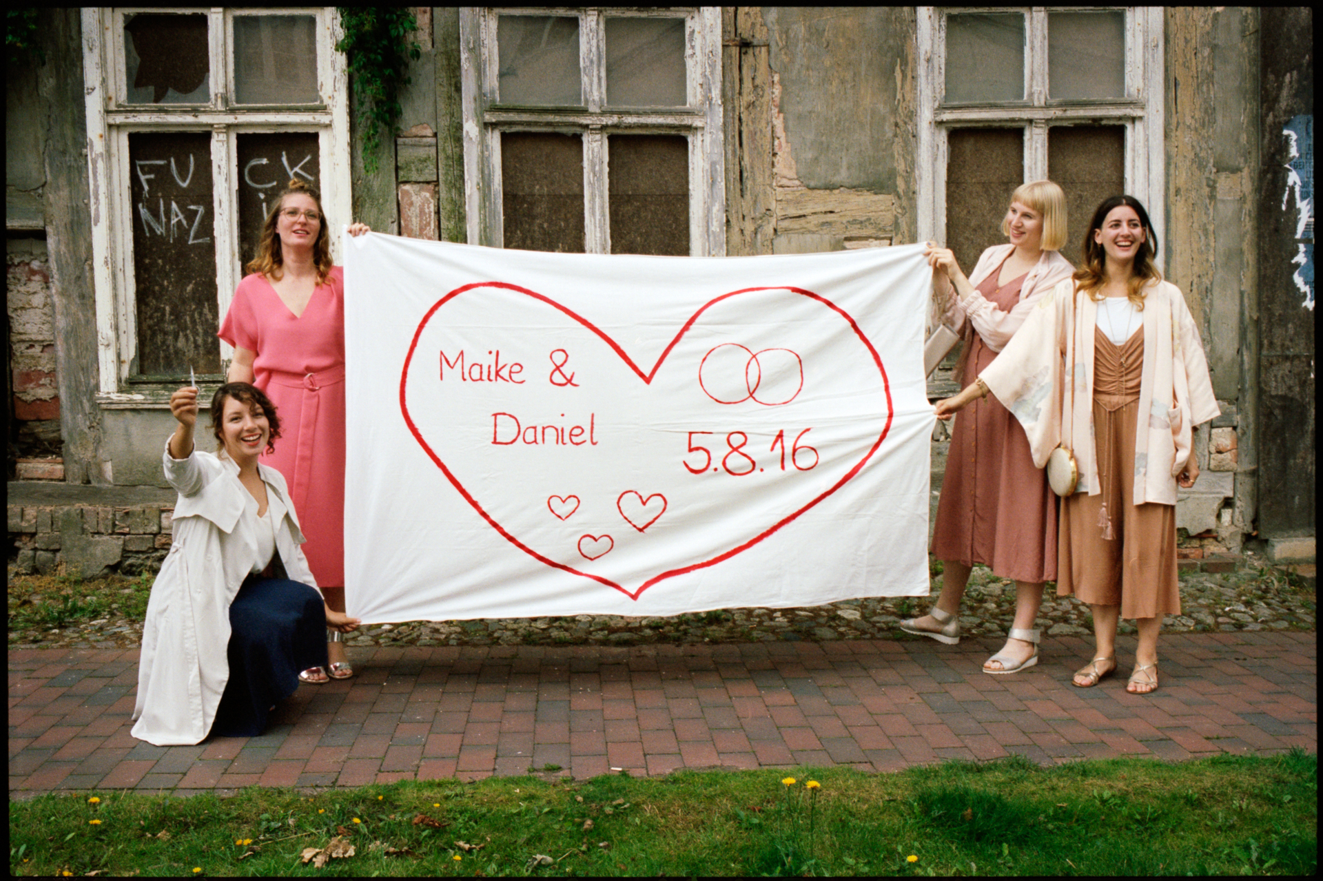 Guests holding a banner for Maike and Daniel, Maike & Daniel wedding in Brandenburg