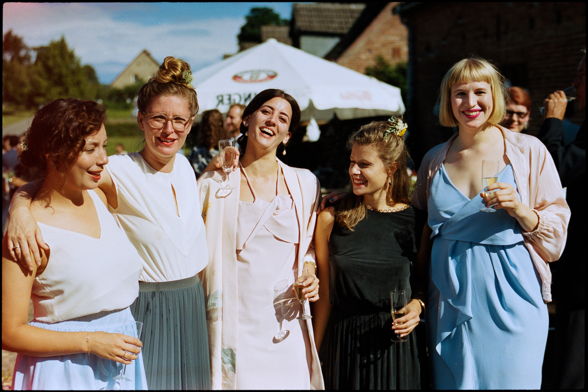 A group of guests together, a marquee behind them, Maike & Daniel wedding in Brandenburg