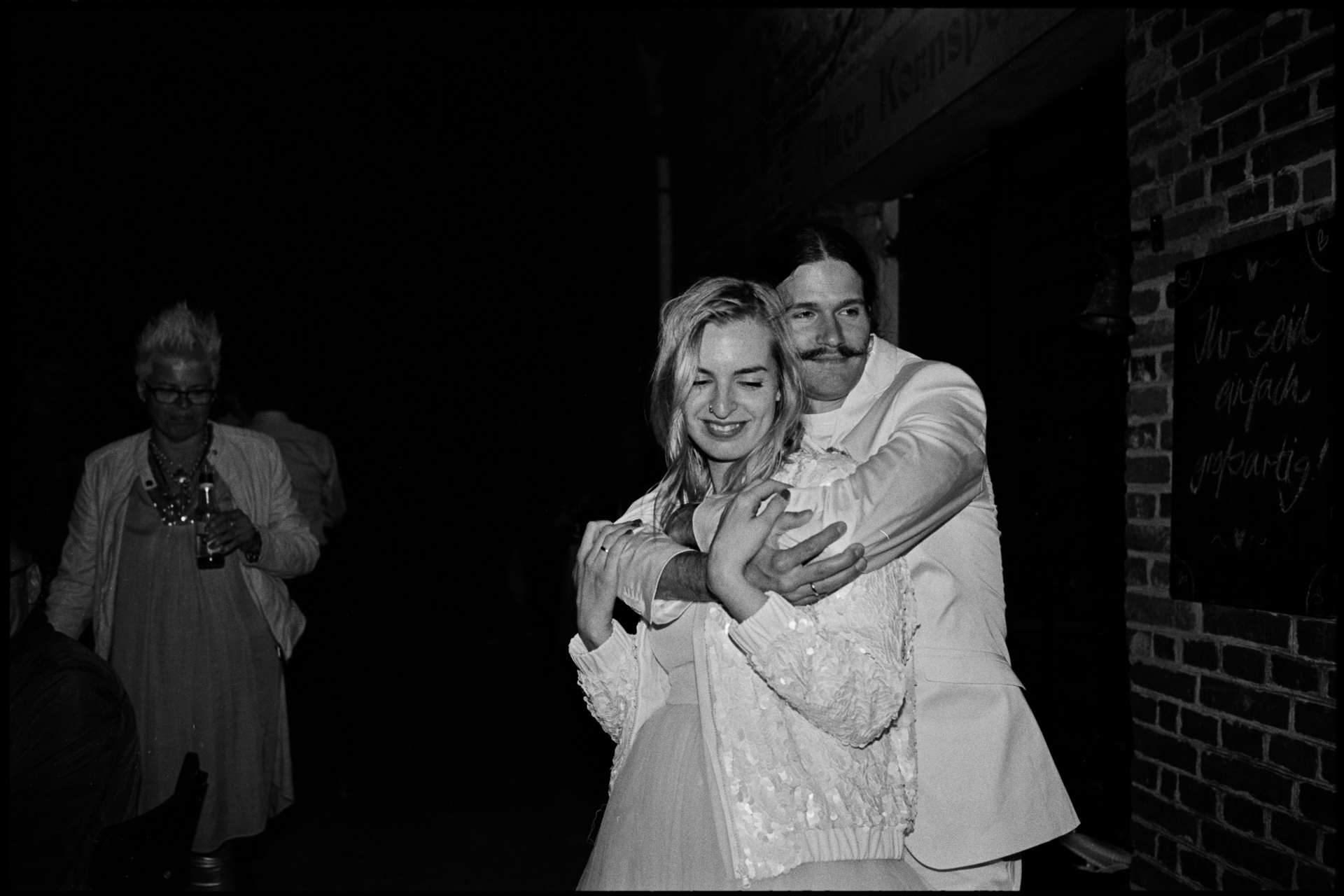 The bride and groom embracing, in black and white, Maike & Daniel wedding in Brandenburg