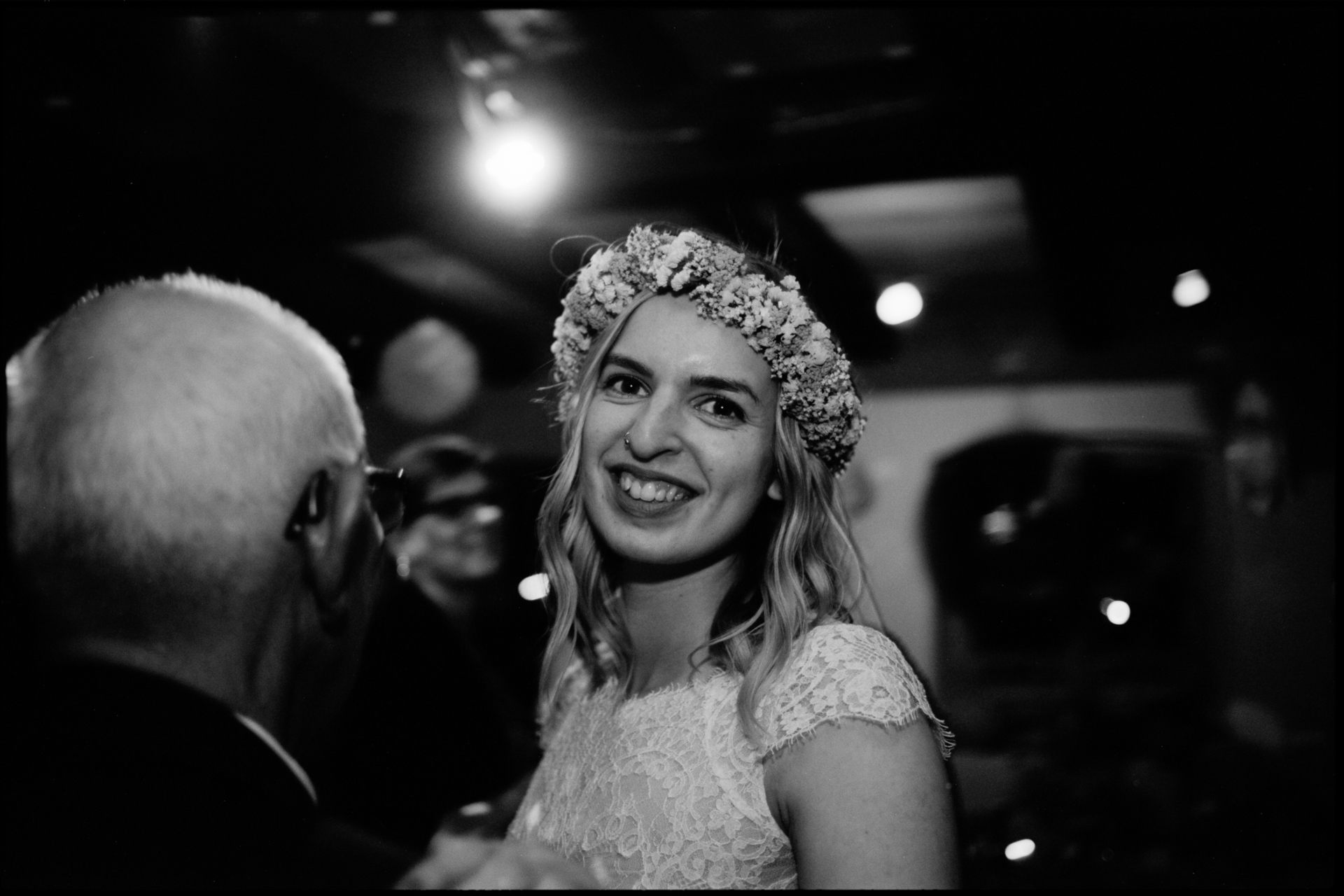 The bride greeting an older guest, in black and white, Maike & Daniel wedding in Brandenburg