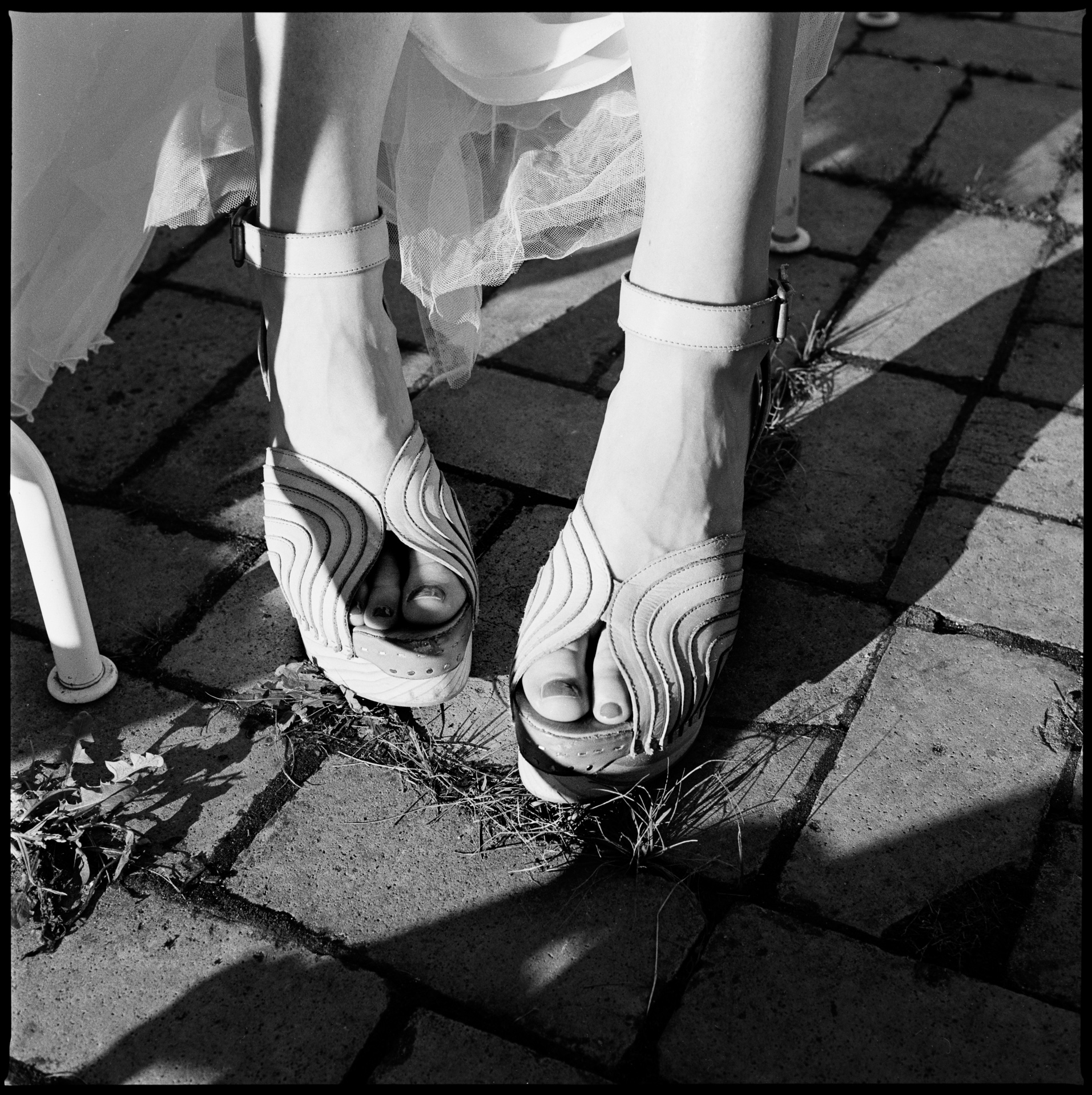 The bride's shoes on cobblestones, in black and white, Maike & Daniel wedding in Brandenburg
