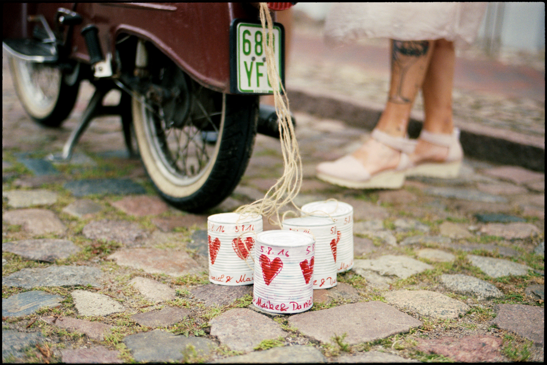 Tin cans painted with hearts tied to the wedding scooter, Maike & Daniel wedding in Brandenburg