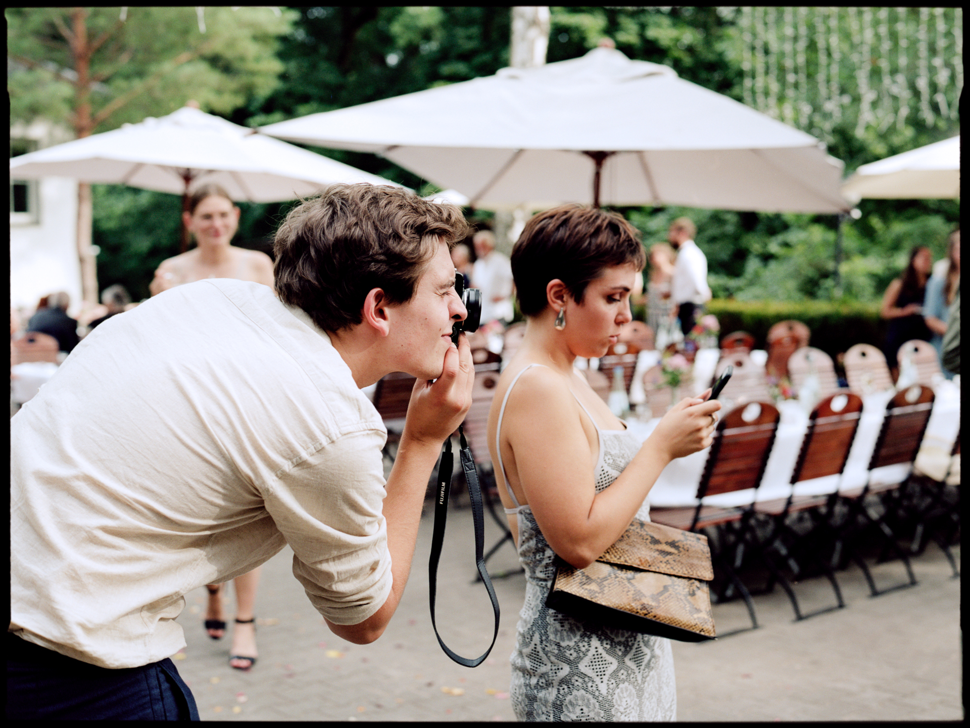 A guest greeting another at the table, Suelyn & Pascal wedding in Groß Glienicke, Potsdam