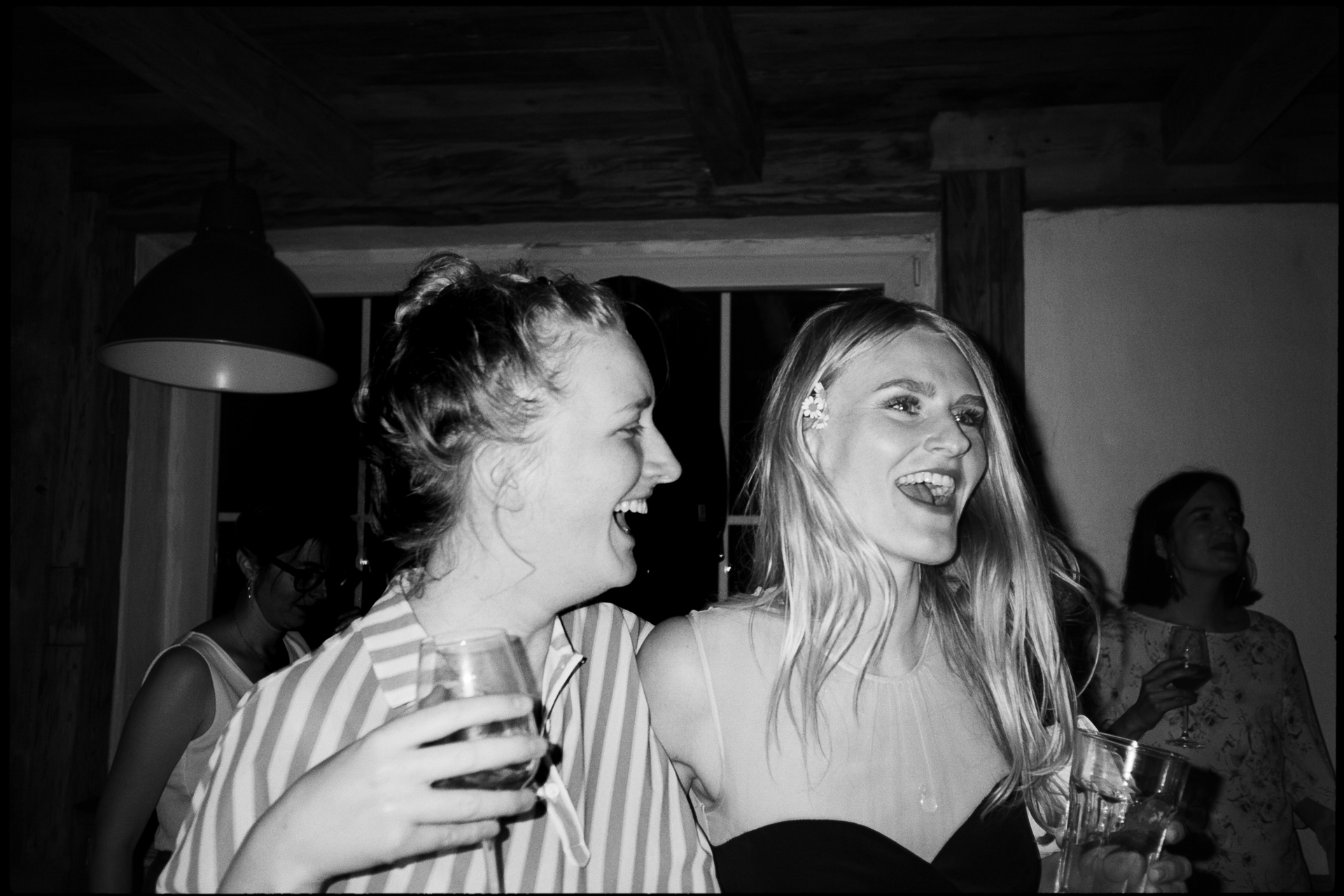Two guests laughing together, in black and white, Suelyn & Pascal wedding in Groß Glienicke, Potsdam