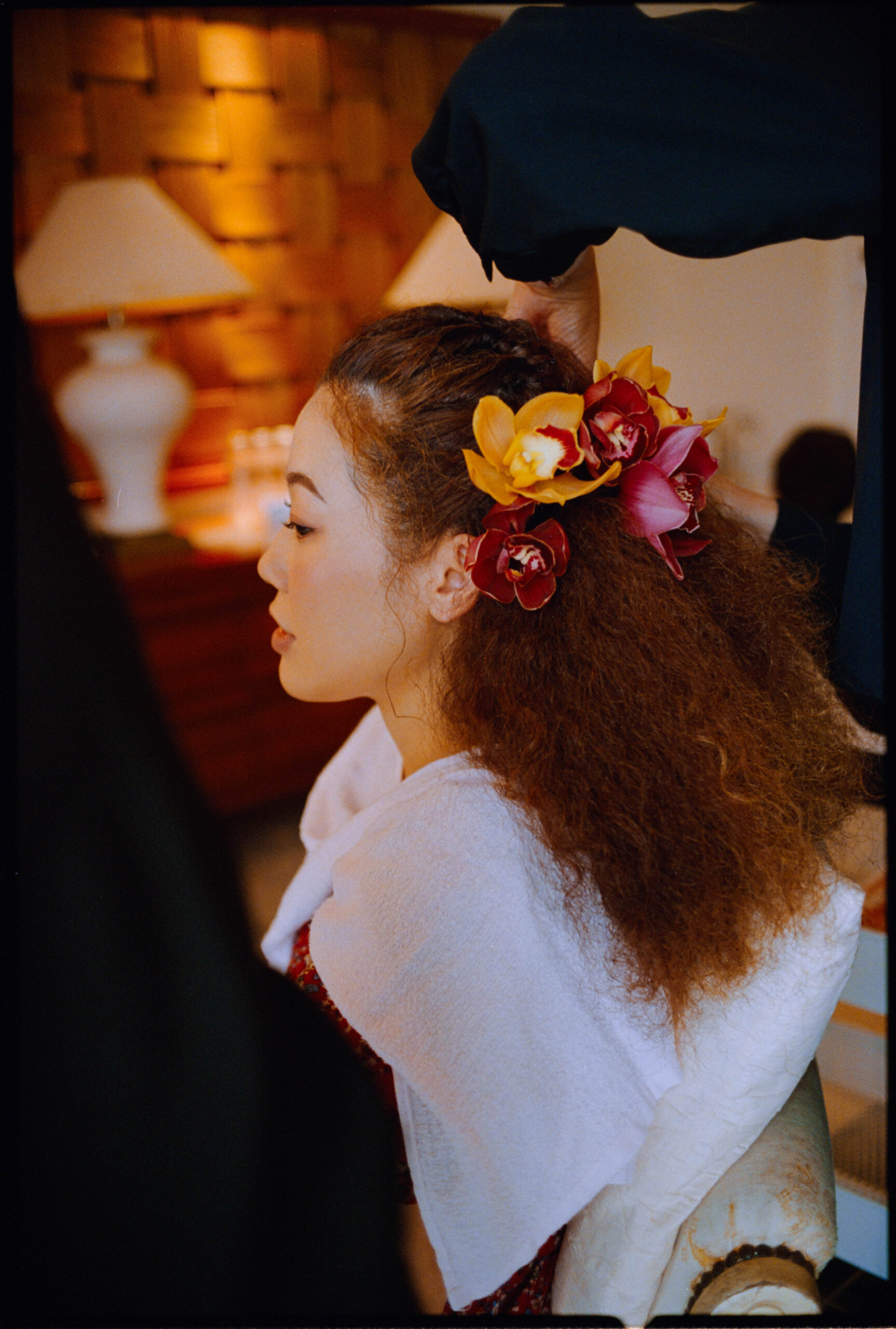The bride getting ready, a flower in her hair, Sugano & Jonas wedding in Okinawa