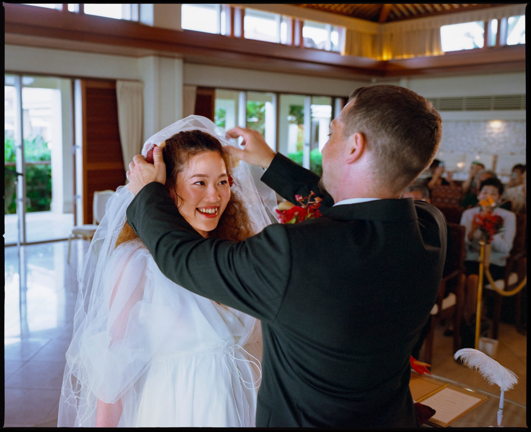 The groom lifting the bride's veil, Sugano & Jonas wedding in Okinawa
