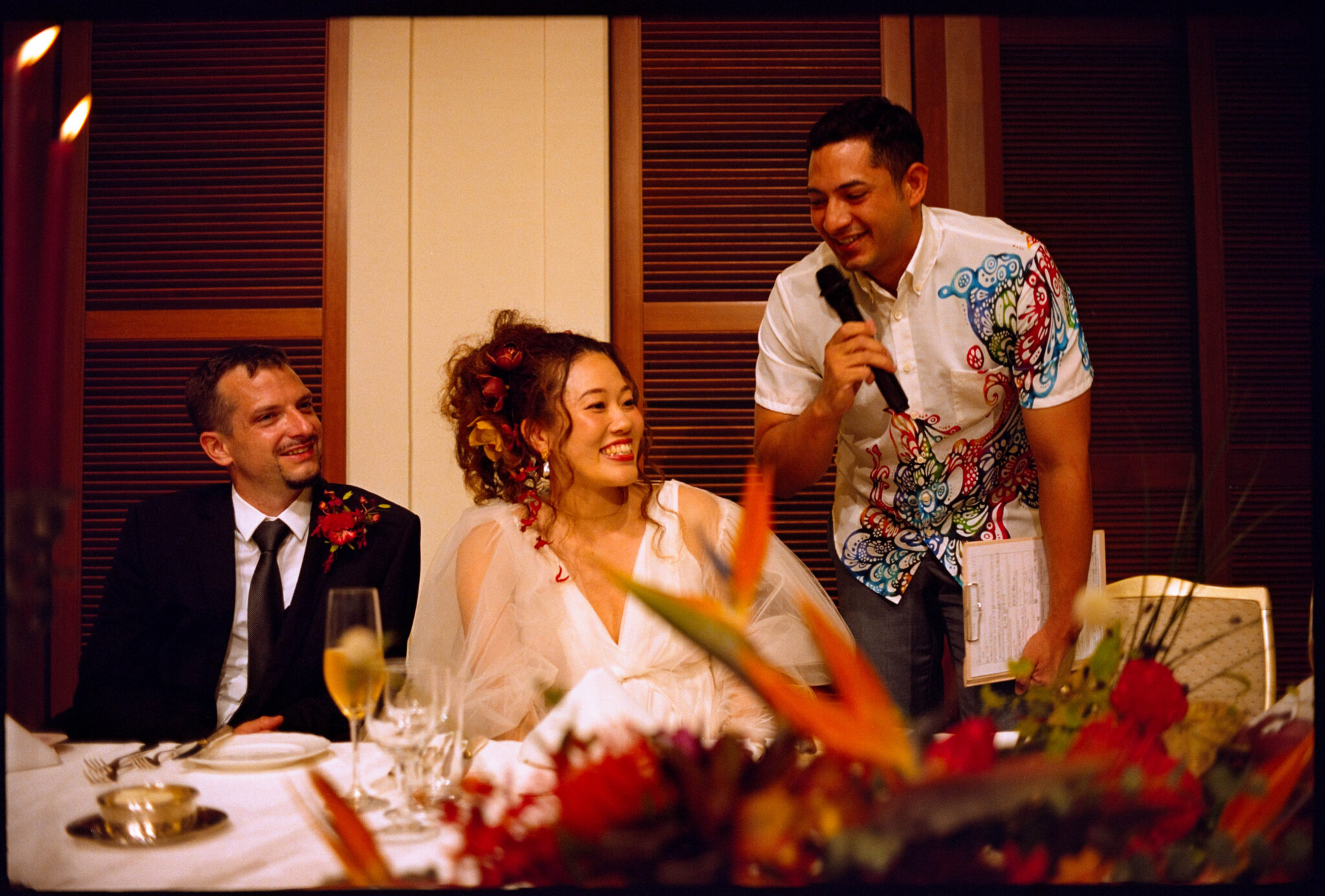 The couple laughing with a guest at the table, Sugano & Jonas wedding in Okinawa