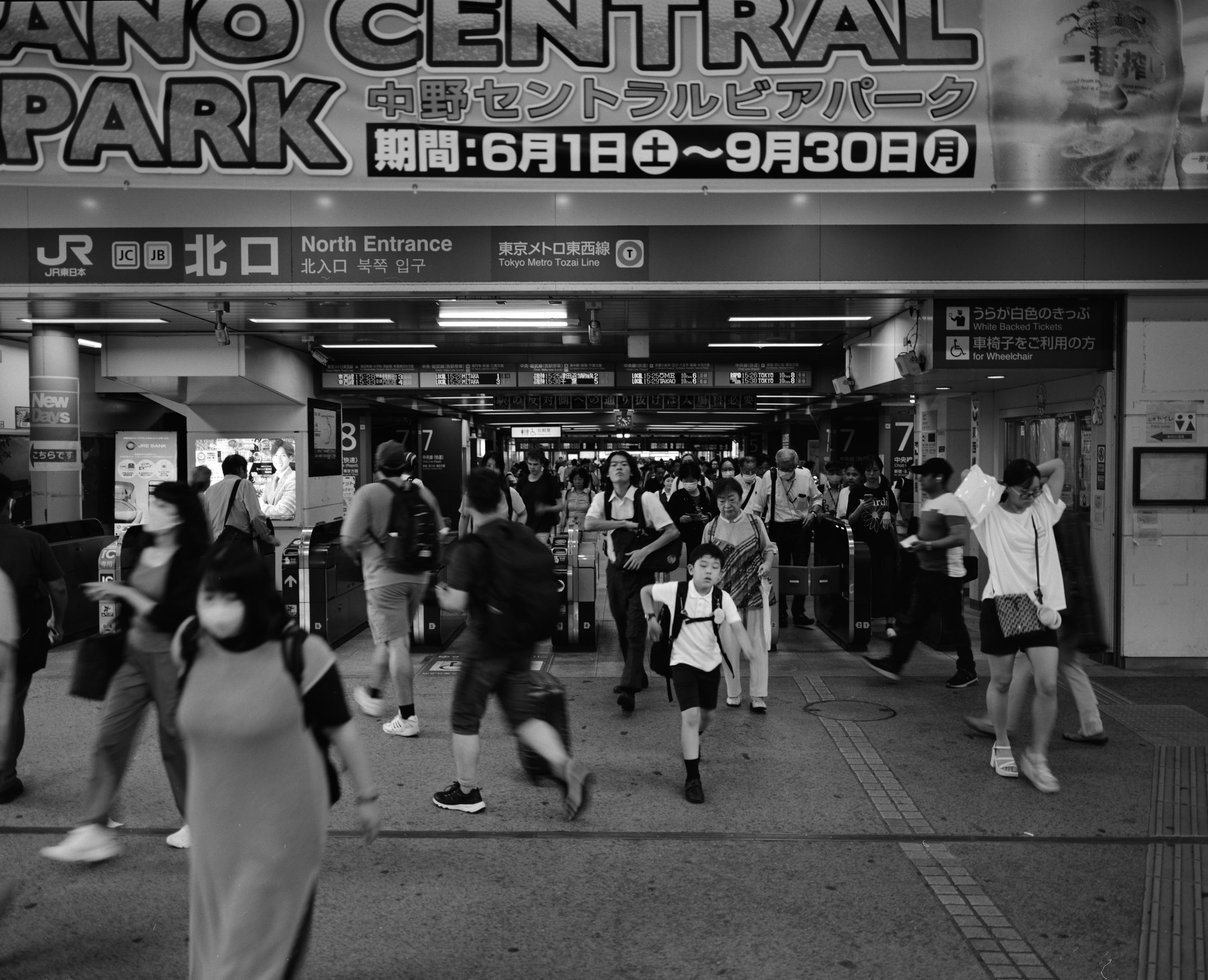Commuters passing through the ticket gates at Nakano Station, Tokyo
