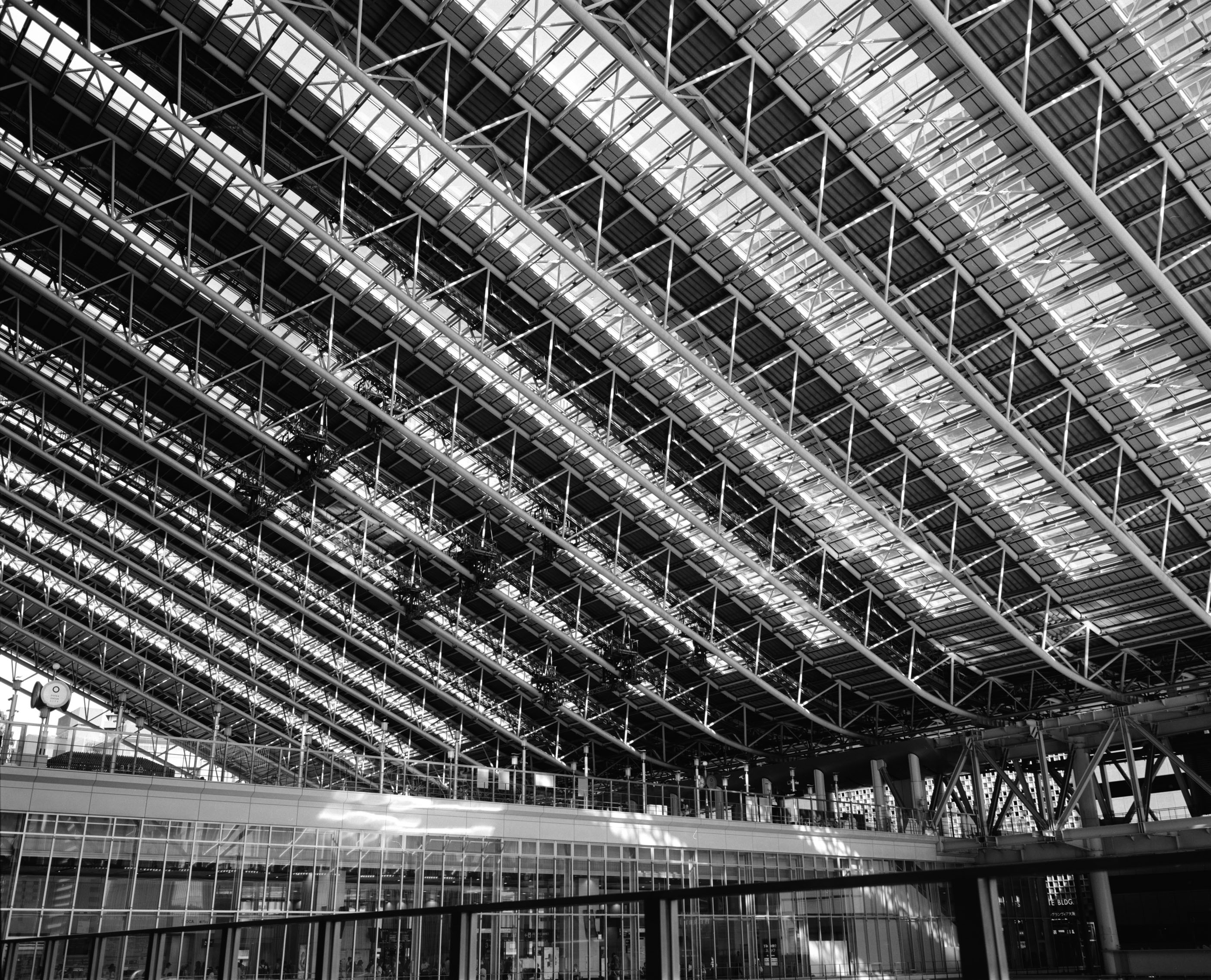 Steel roof structure spanning the atrium of Osaka Station, daylight falling through the skylights