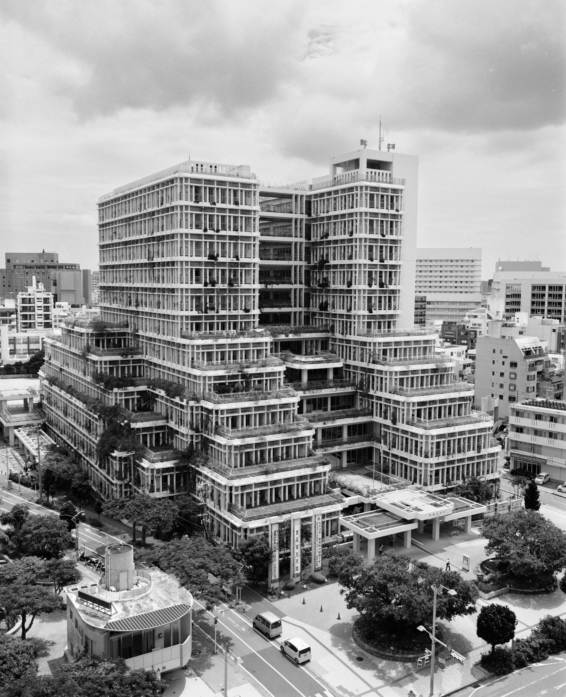 Stepped concrete high-rise with plants overflowing from every terrace